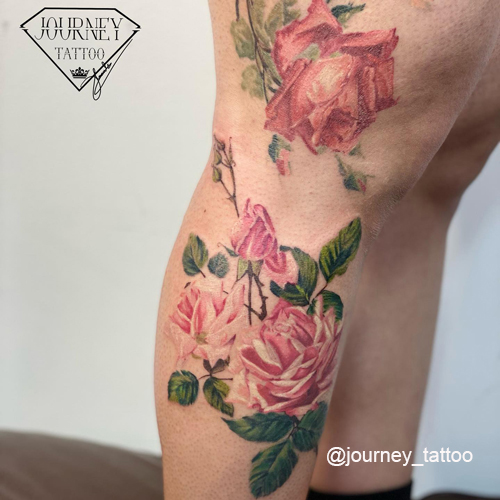 rose flower tattoo on legs