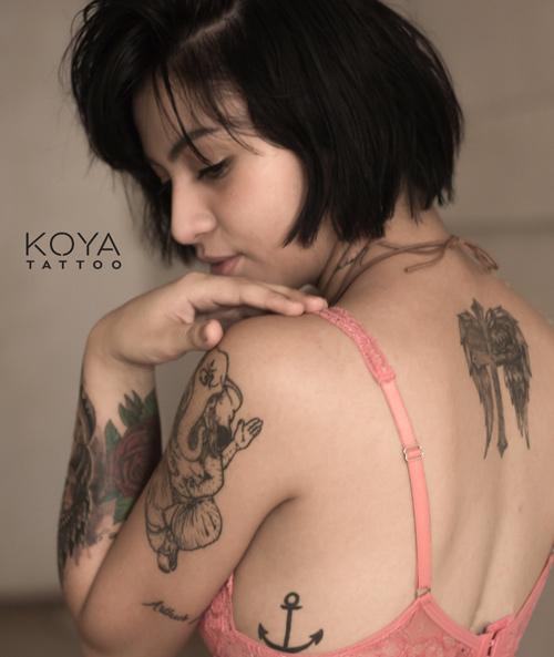 woman with tattoos on her back and hand