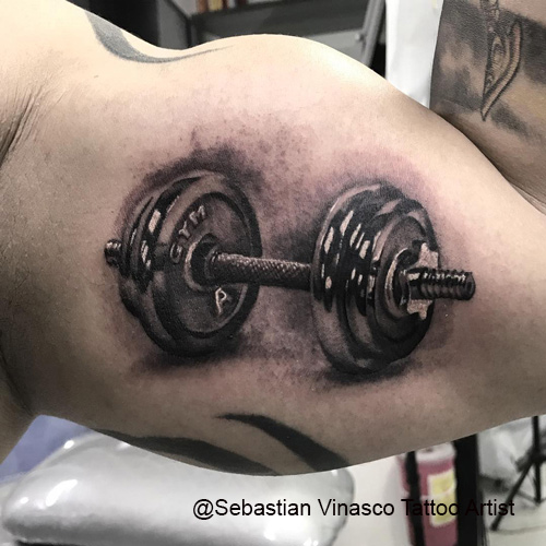 dumbbells tattoo on biceps by Sebastian Vinasco Tattoo Artist